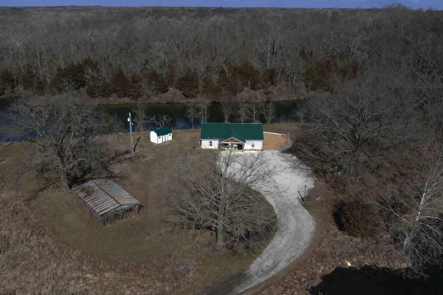Aerial view of Timber & Threads Retreat on a private island surrounded by the Missouri Ozarks lake